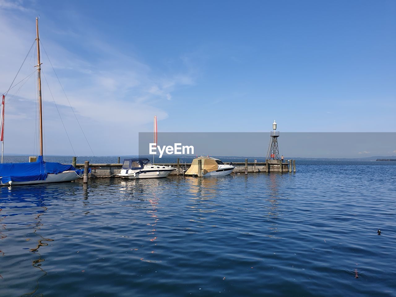 SAILBOATS MOORED ON SEA AGAINST SKY