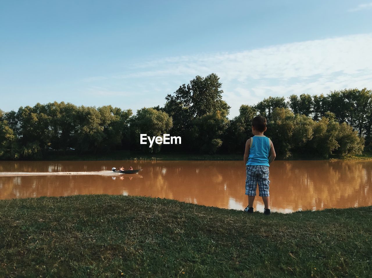 Full length of boy looking at river