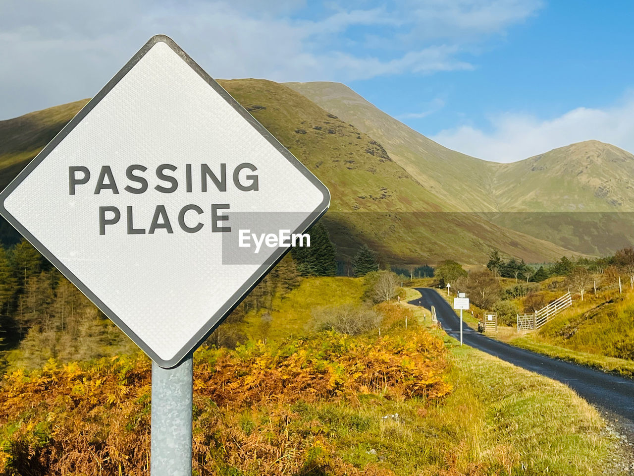 Low angle view of road sign against sky