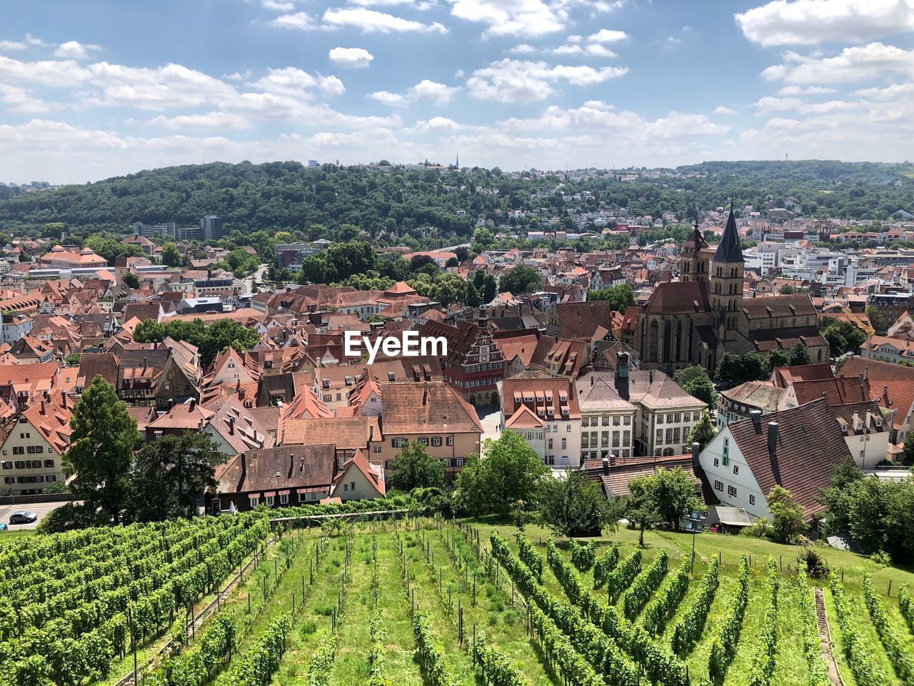 HIGH ANGLE VIEW OF TOWNSCAPE AGAINST CLOUDY SKY