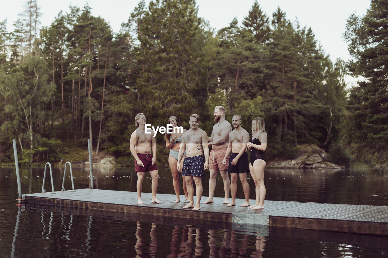 Friends standing on jetty