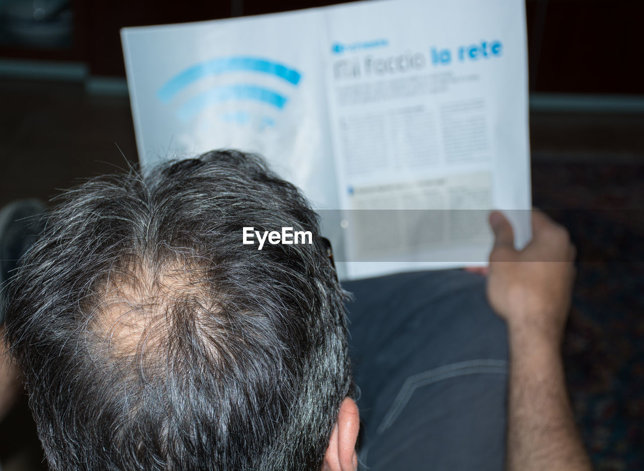 High angle view of man reading document