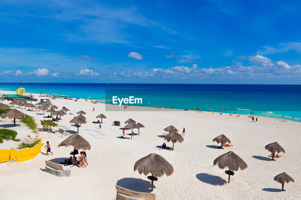 SCENIC VIEW OF BEACH AGAINST BLUE SKY