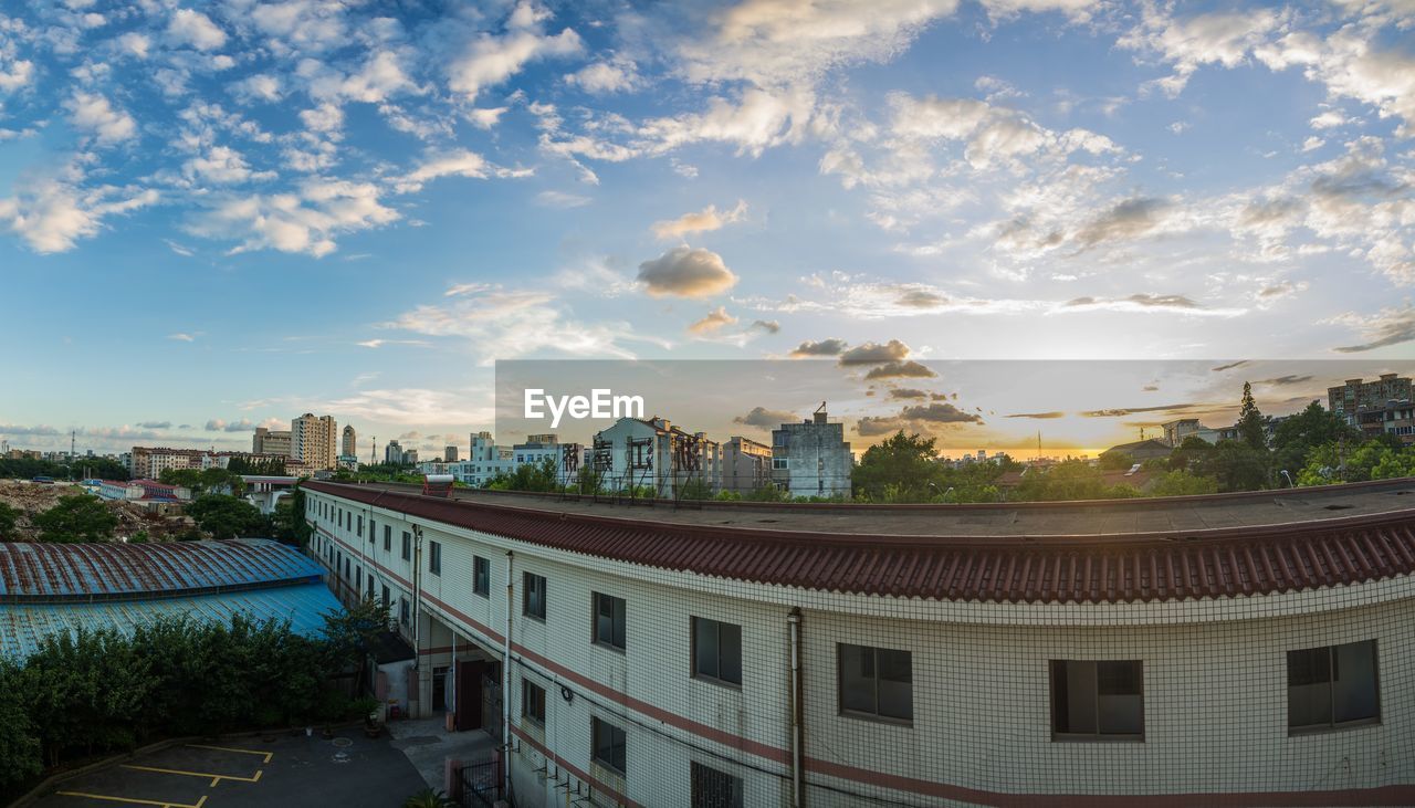 View of cityscape against cloudy sky