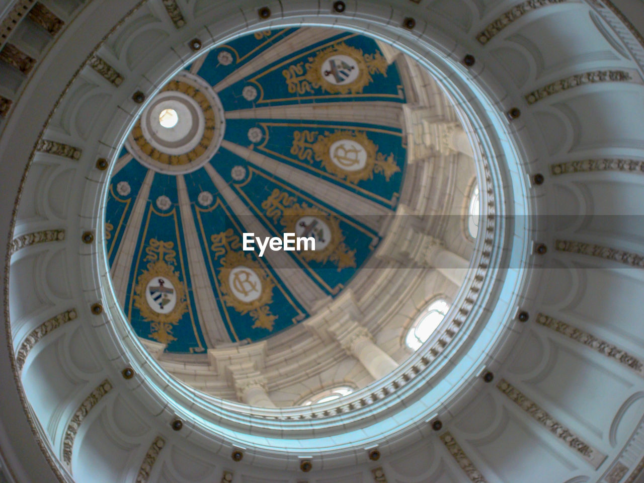 LOW ANGLE VIEW OF ORNATE CEILING IN THE DARK