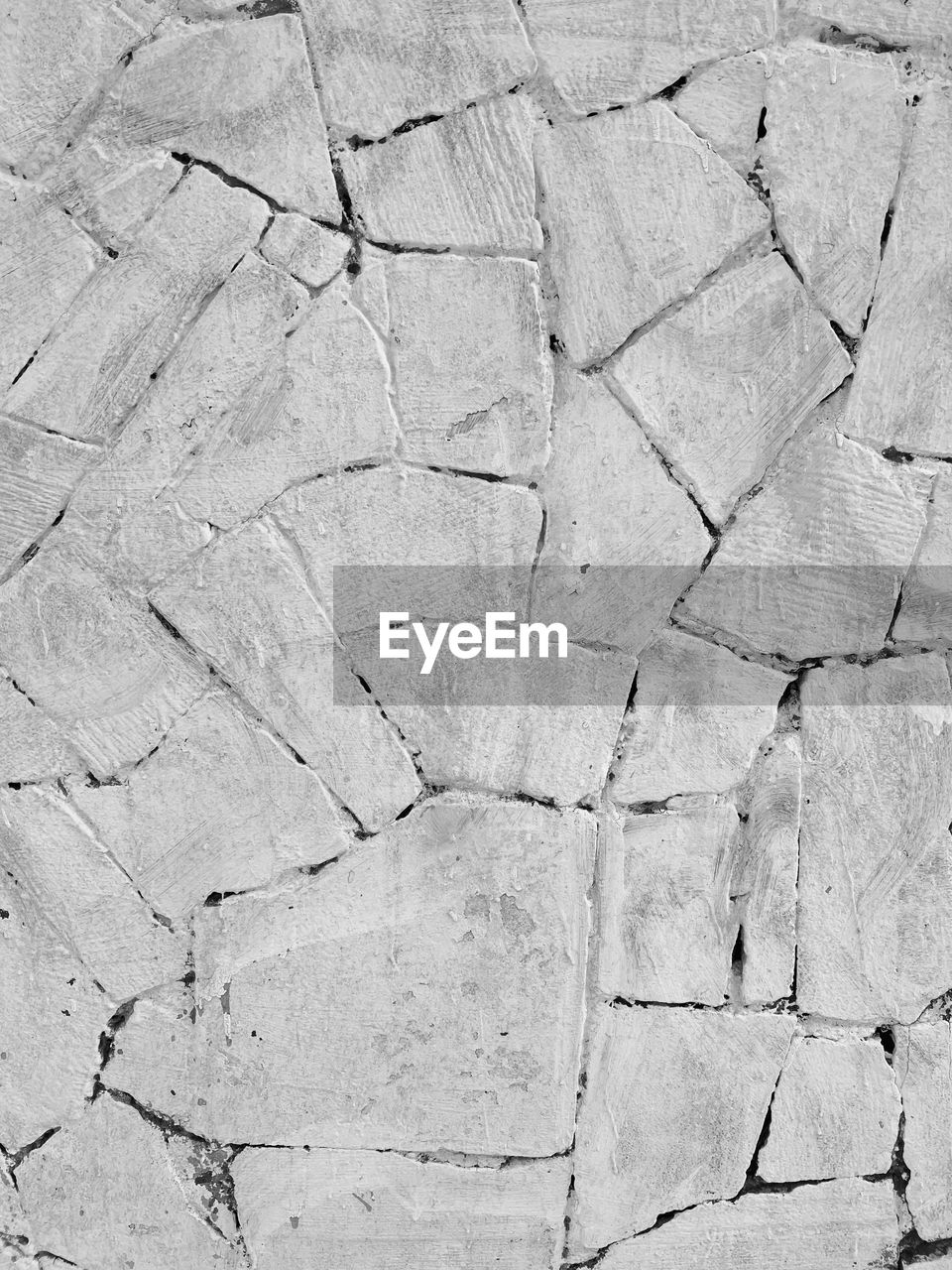 backgrounds, full frame, pattern, textured, cracked, no people, road surface, stone wall, wall, day, rough, asphalt, floor, black and white, flooring, outdoors, nature, soil, close-up, built structure, high angle view, line, stone material, architecture, arid climate, wall - building feature, monochrome, climate, rock, dry