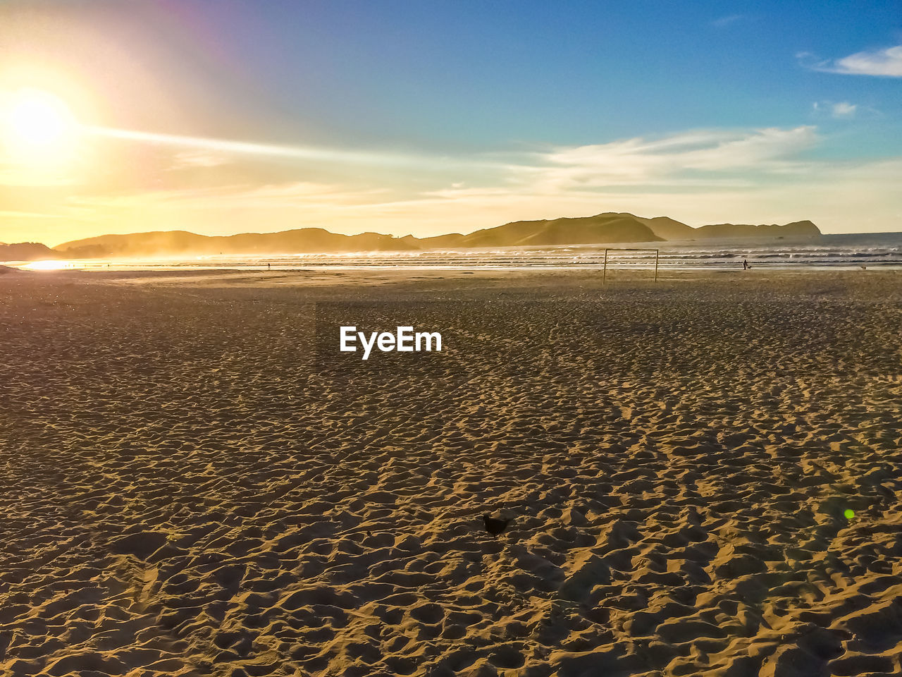 Scenic view of beach against sky during sunset