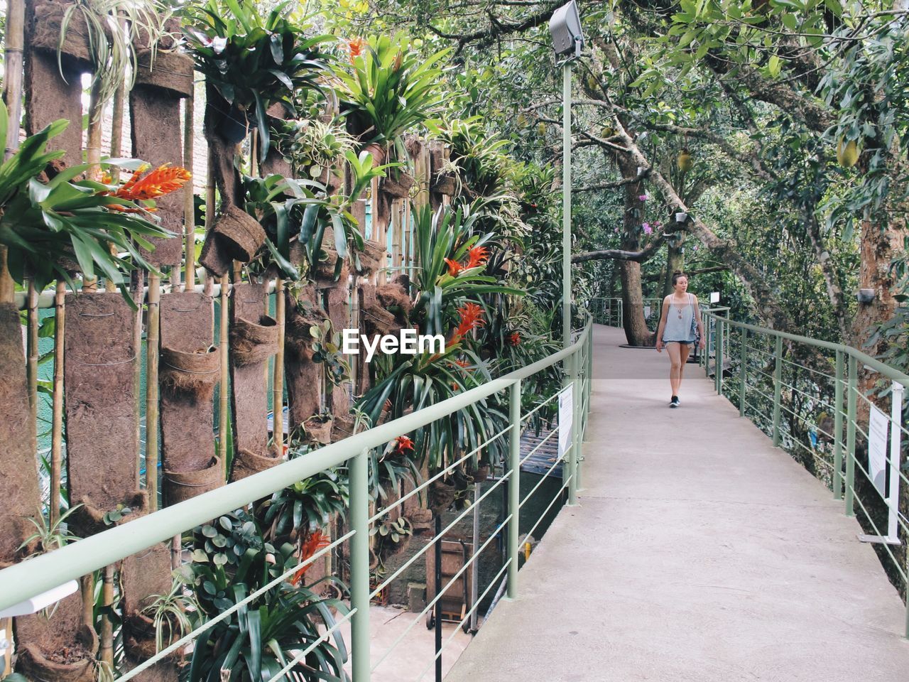 Full length of woman walking on footbridge