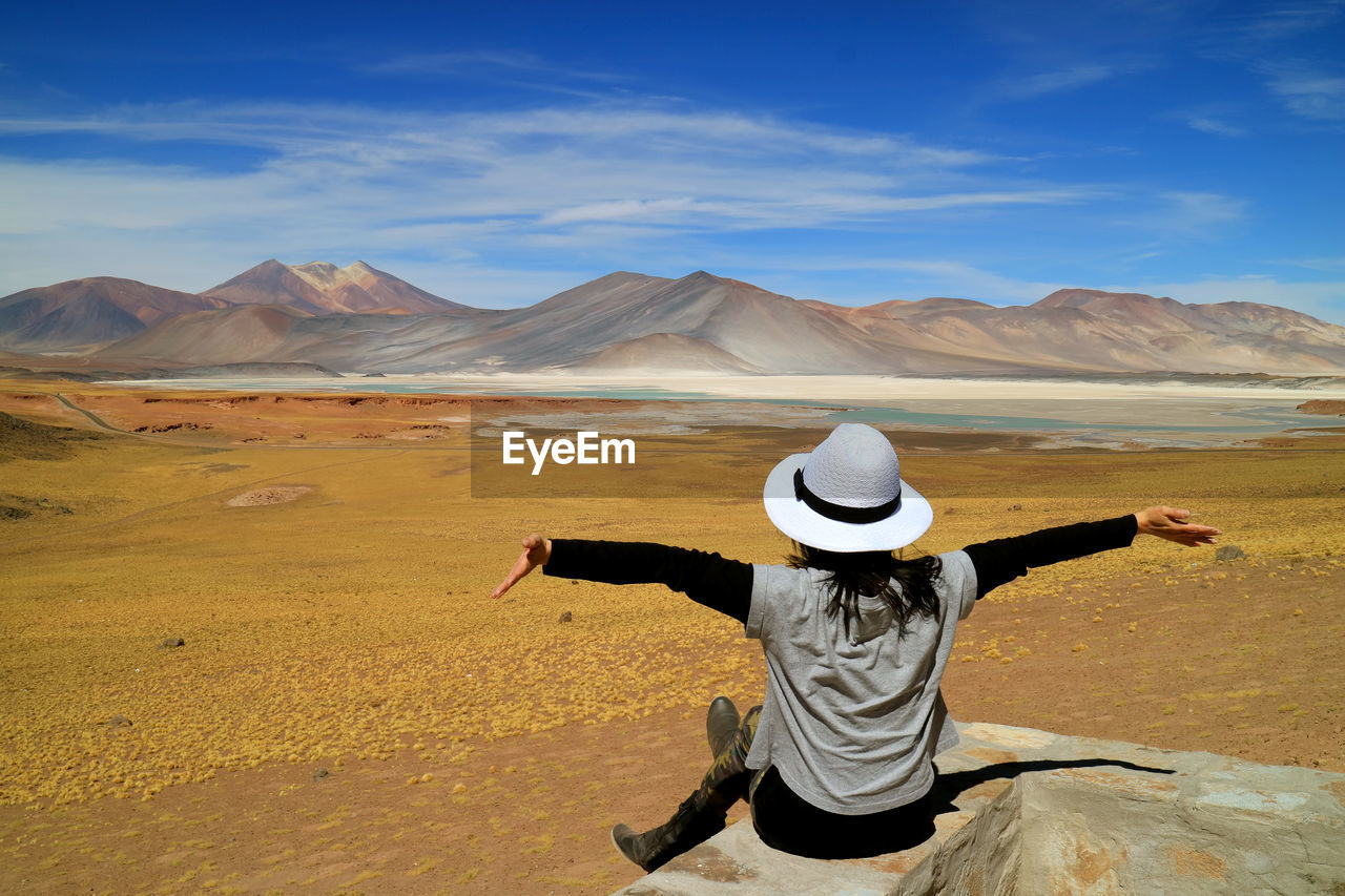 Rear view of woman wearing hat against mountains