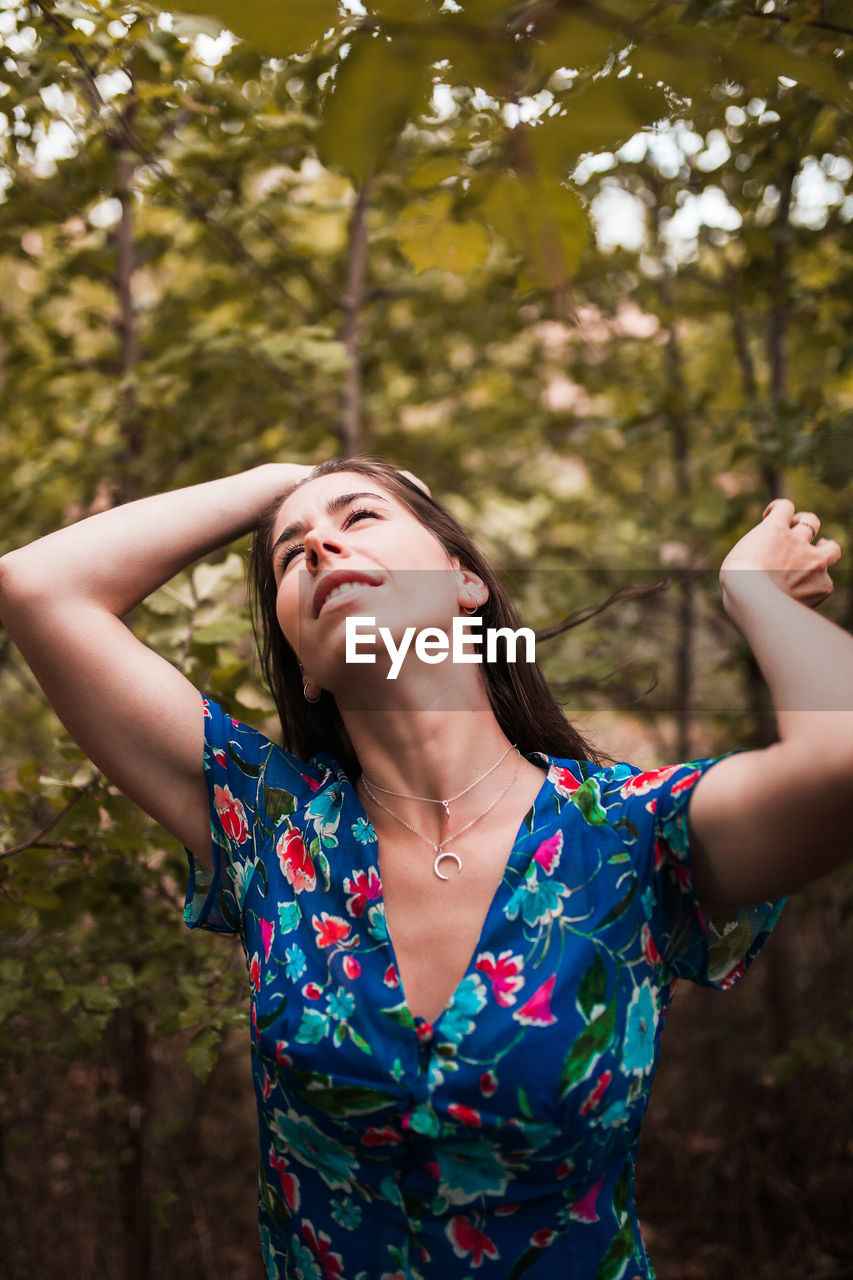 Woman standing on land in forest