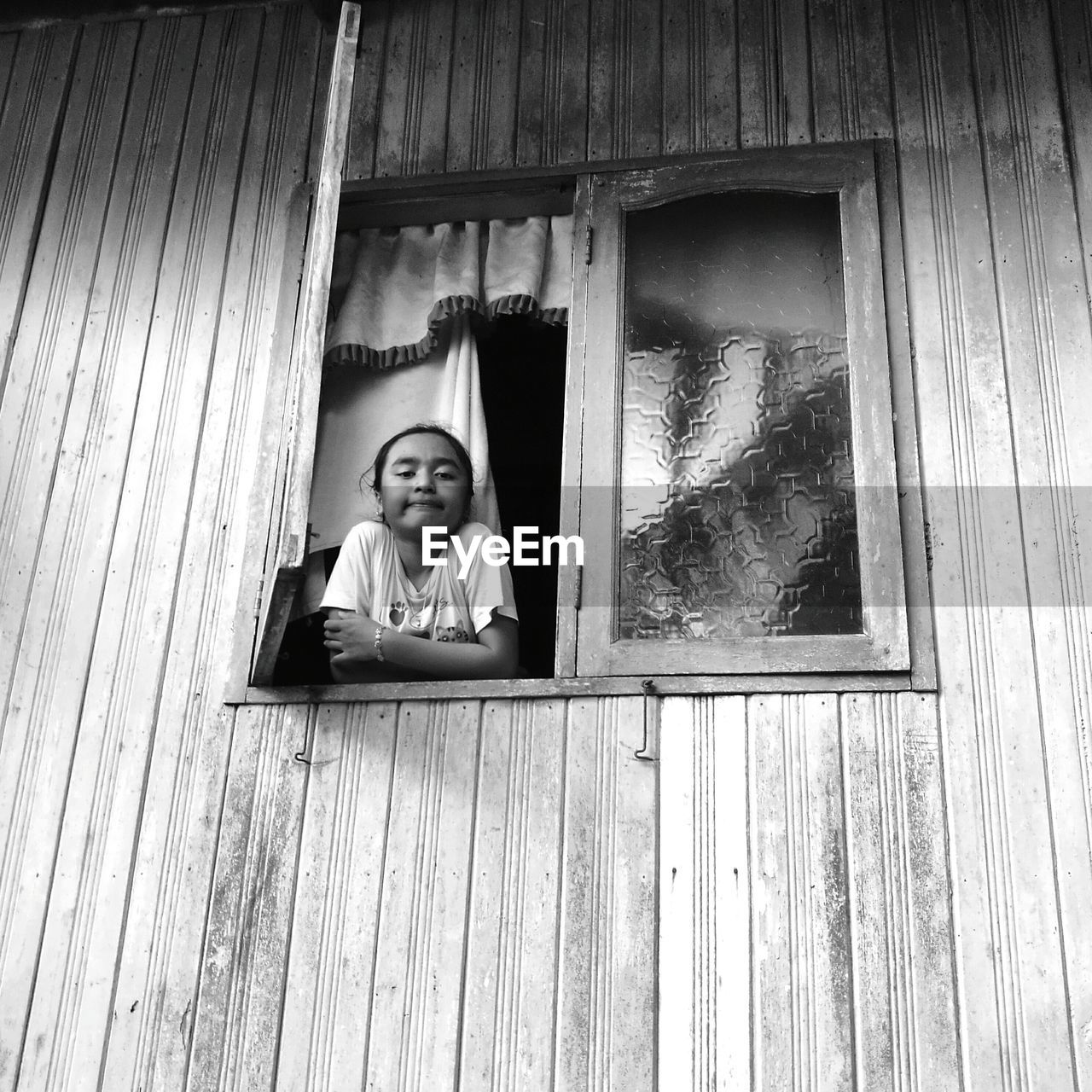 Portrait of girl standing by window