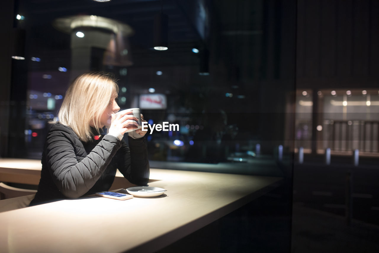 Man looking at illuminated camera