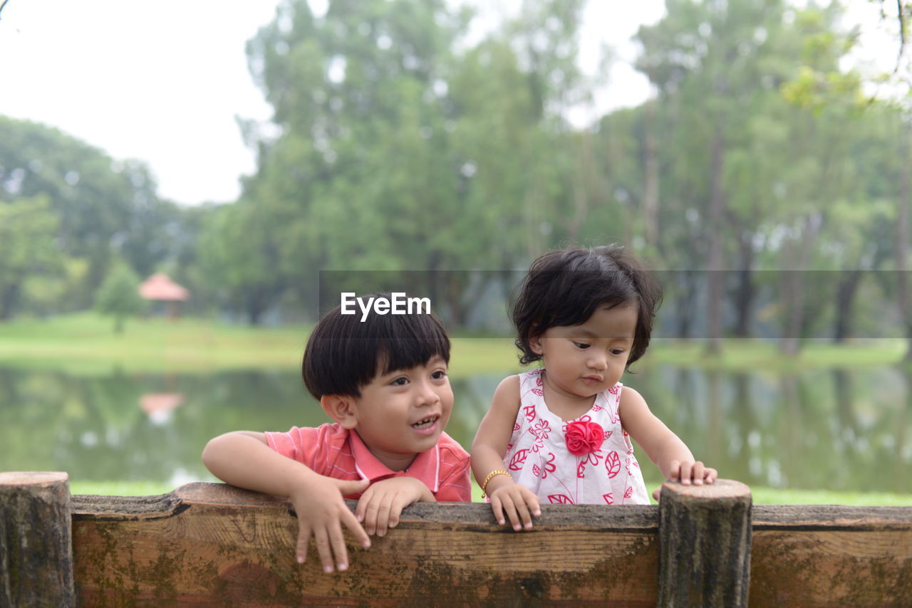 Cute siblings on bench at park