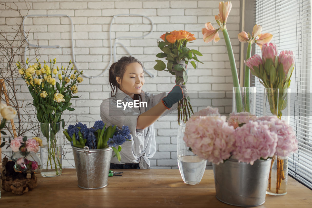 Florist arranging bouquet at flower shop