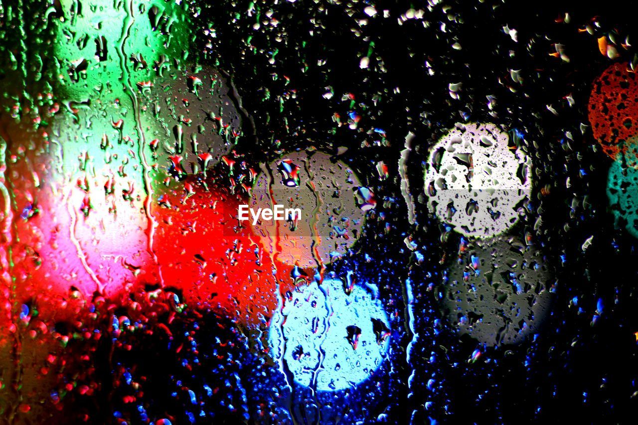 Spotlights seen through wet window