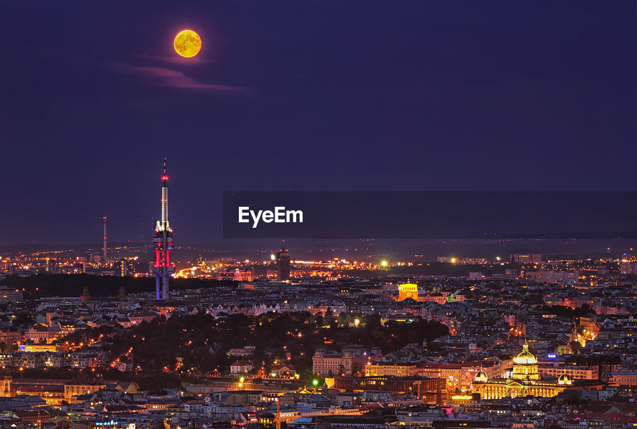 Illuminated cityscape against sky at night