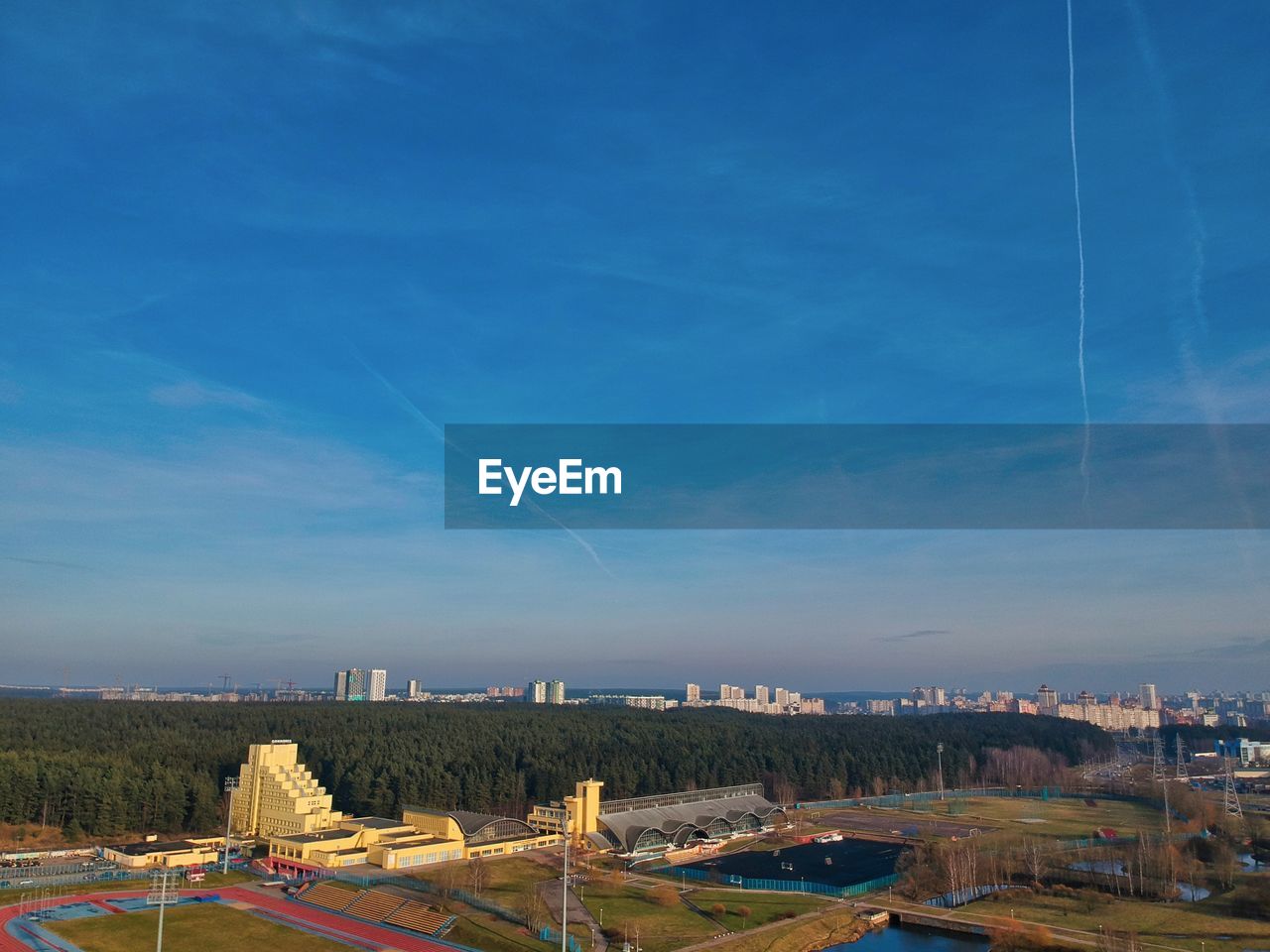 Aerial view of cityscape against blue sky