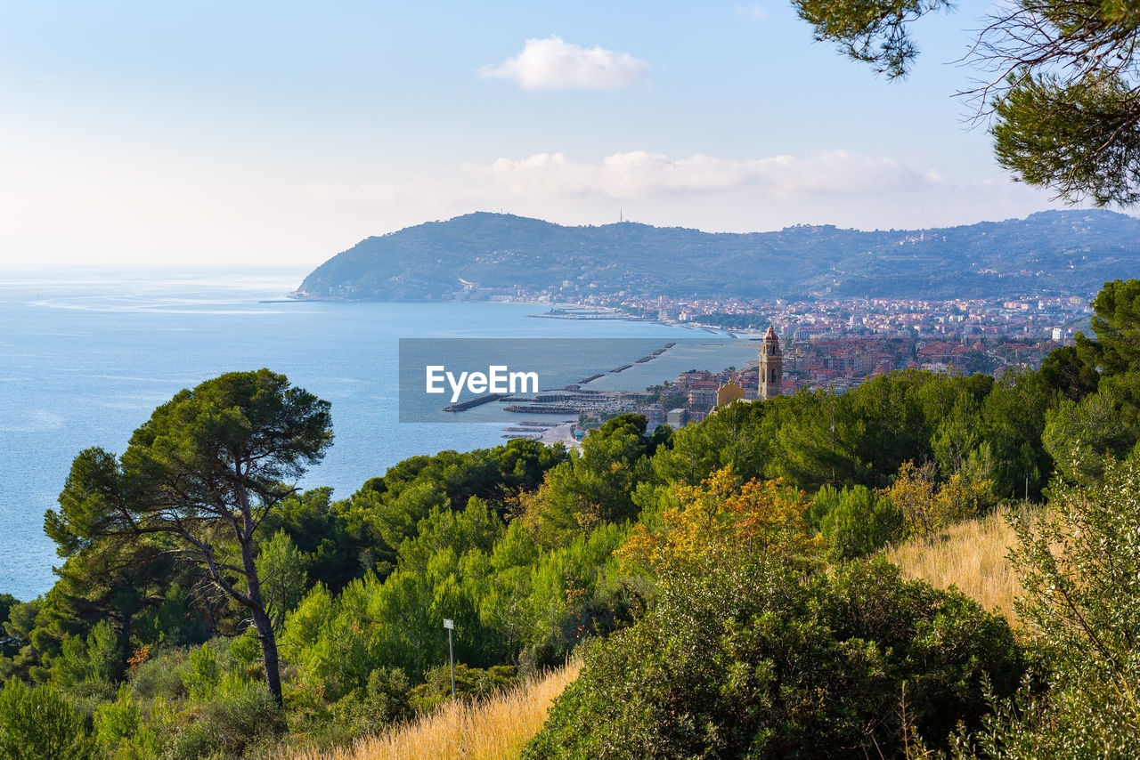 Scenic view of sea and mountains against sky