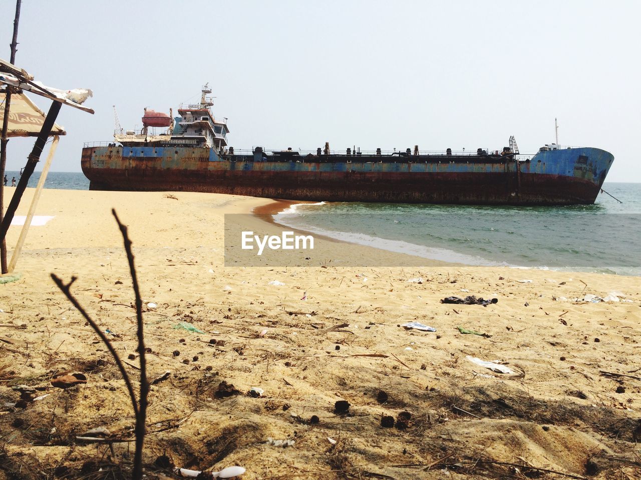 SHIP ON BEACH AGAINST CLEAR SKY