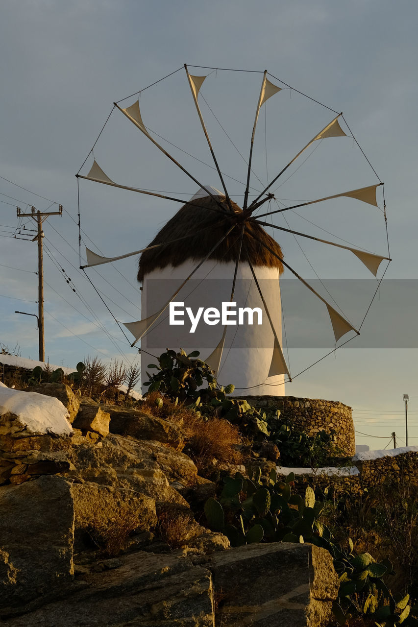 windmill, sky, power generation, renewable energy, technology, environmental conservation, alternative energy, nature, wind power, environment, mill, wind, wind turbine, turbine, architecture, no people, outdoors, built structure, landscape, land, rural scene, traditional windmill, tree, protection