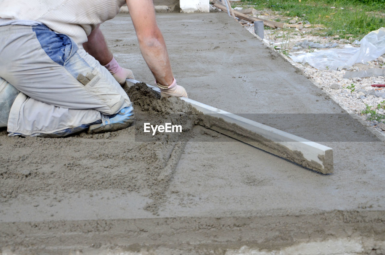 MAN WORKING ON CONSTRUCTION SITE AT HOME