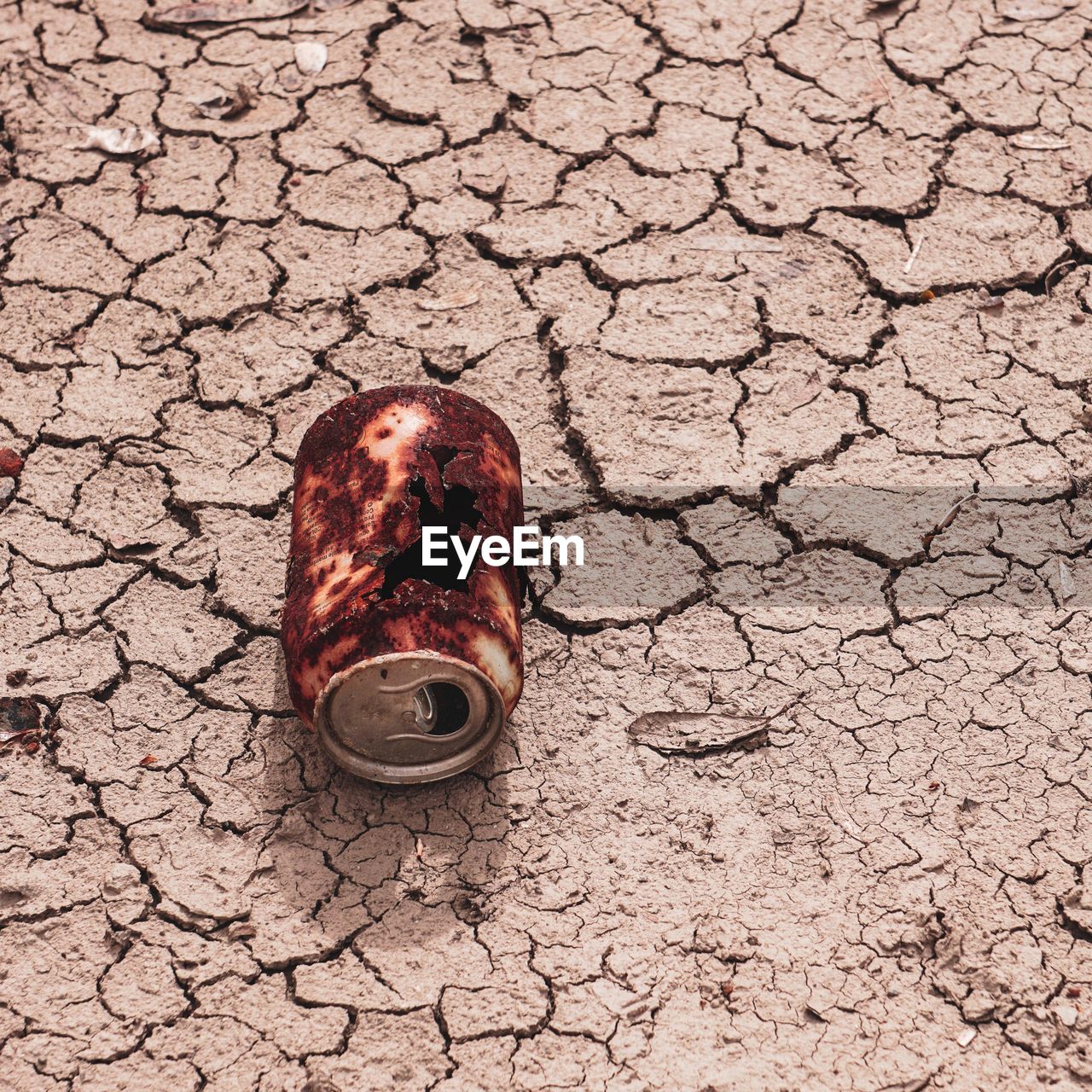 Old rusty can on the desert ground, global warming