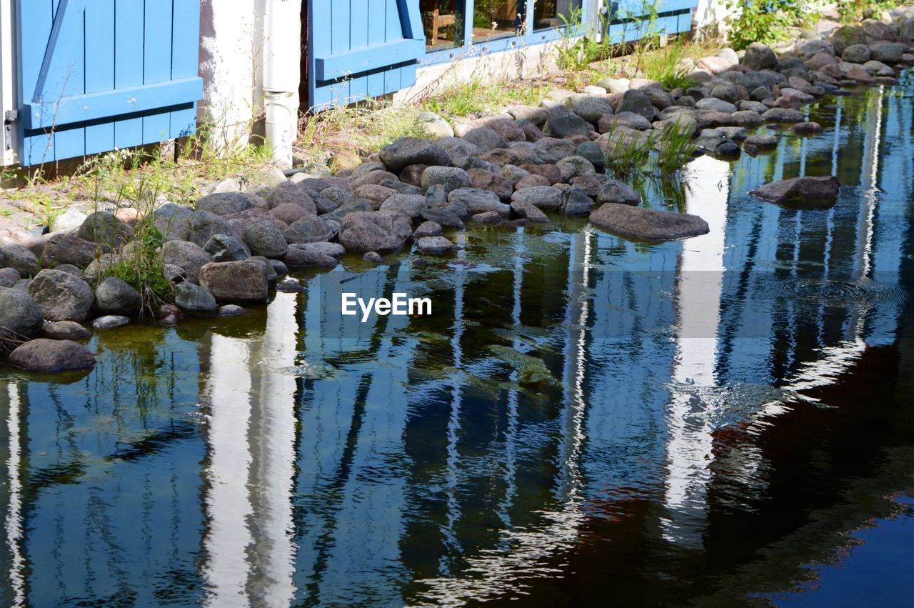 Reflection of fence in stream