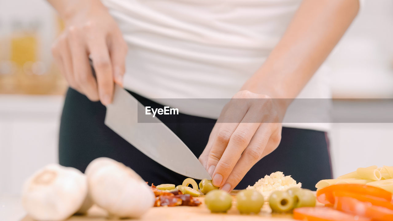 midsection of woman holding food on table