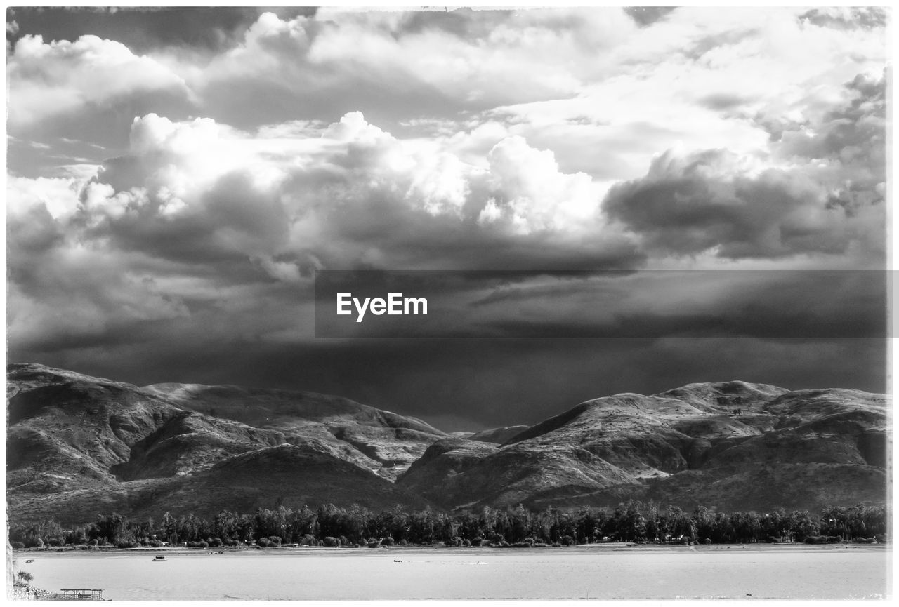 Scenic view of mountains against cloudy sky