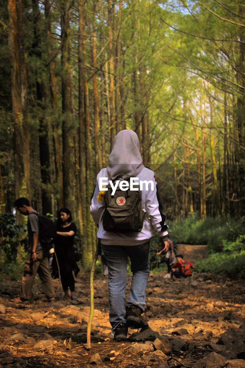 Full length of people walking in forest