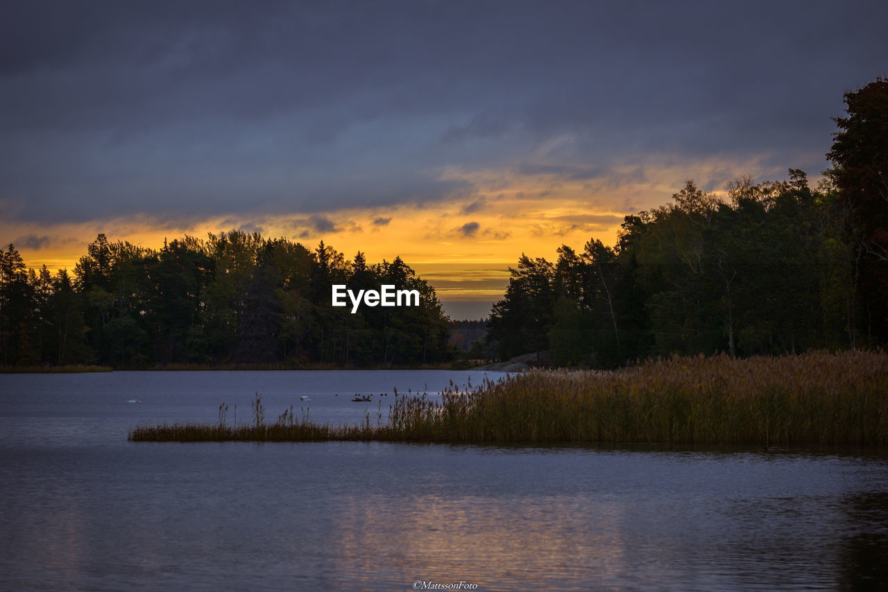 Scenic view of lake against sky during sunset