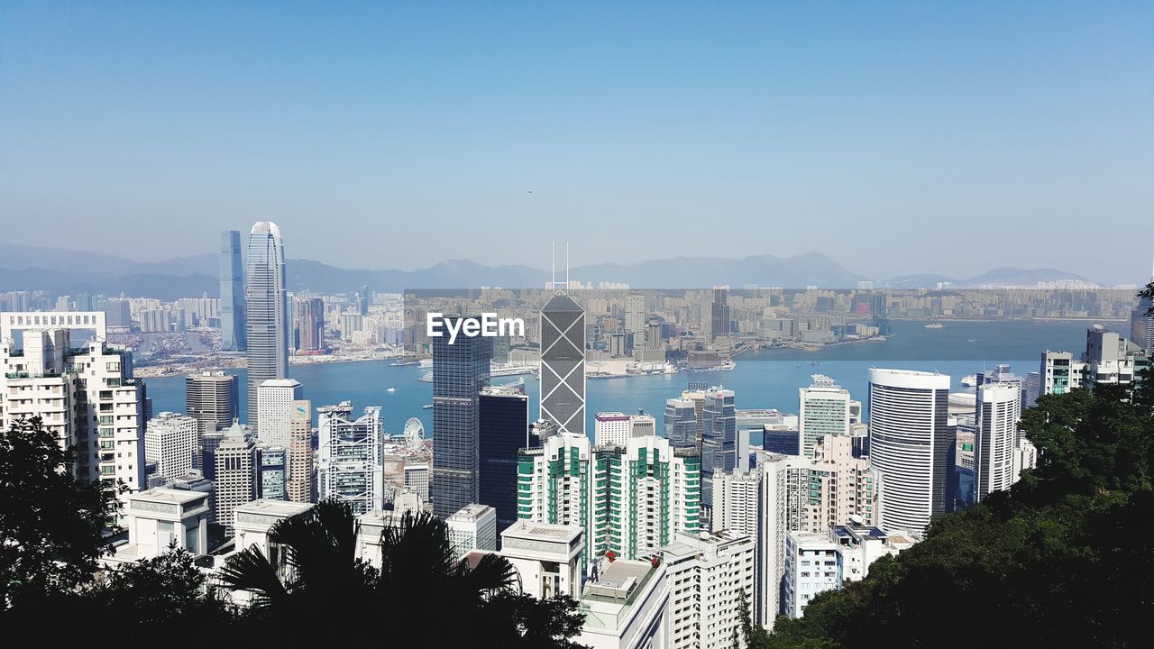 Panoramic view of city by sea against clear sky