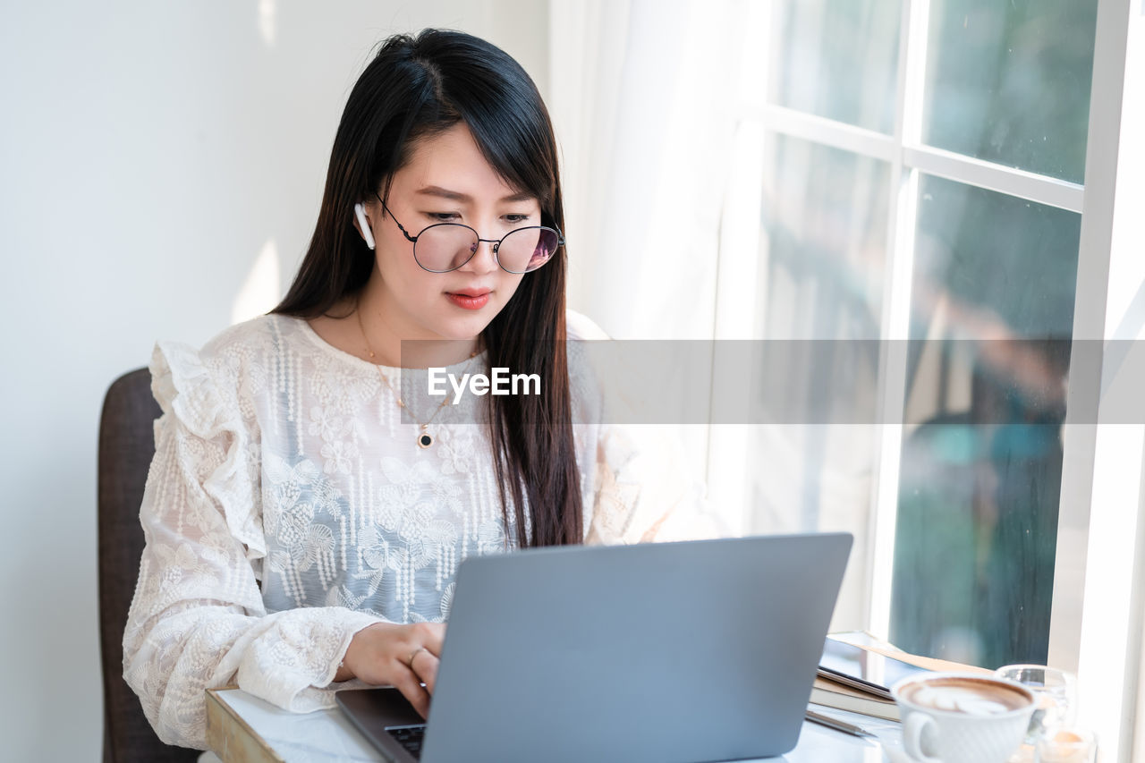 Young woman using laptop at office