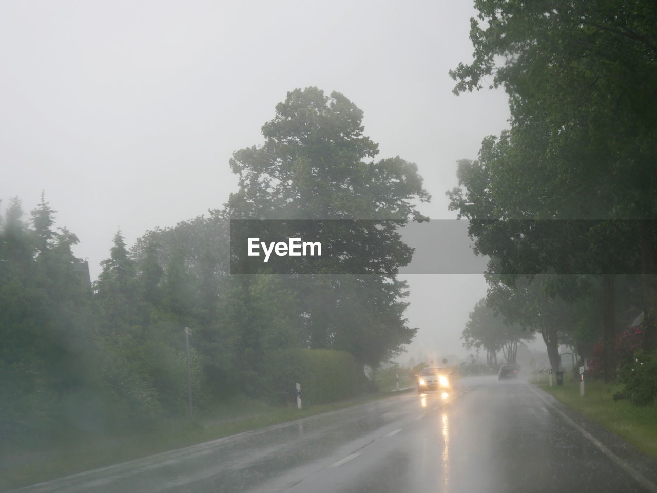 CARS ON ROAD AGAINST CLEAR SKY