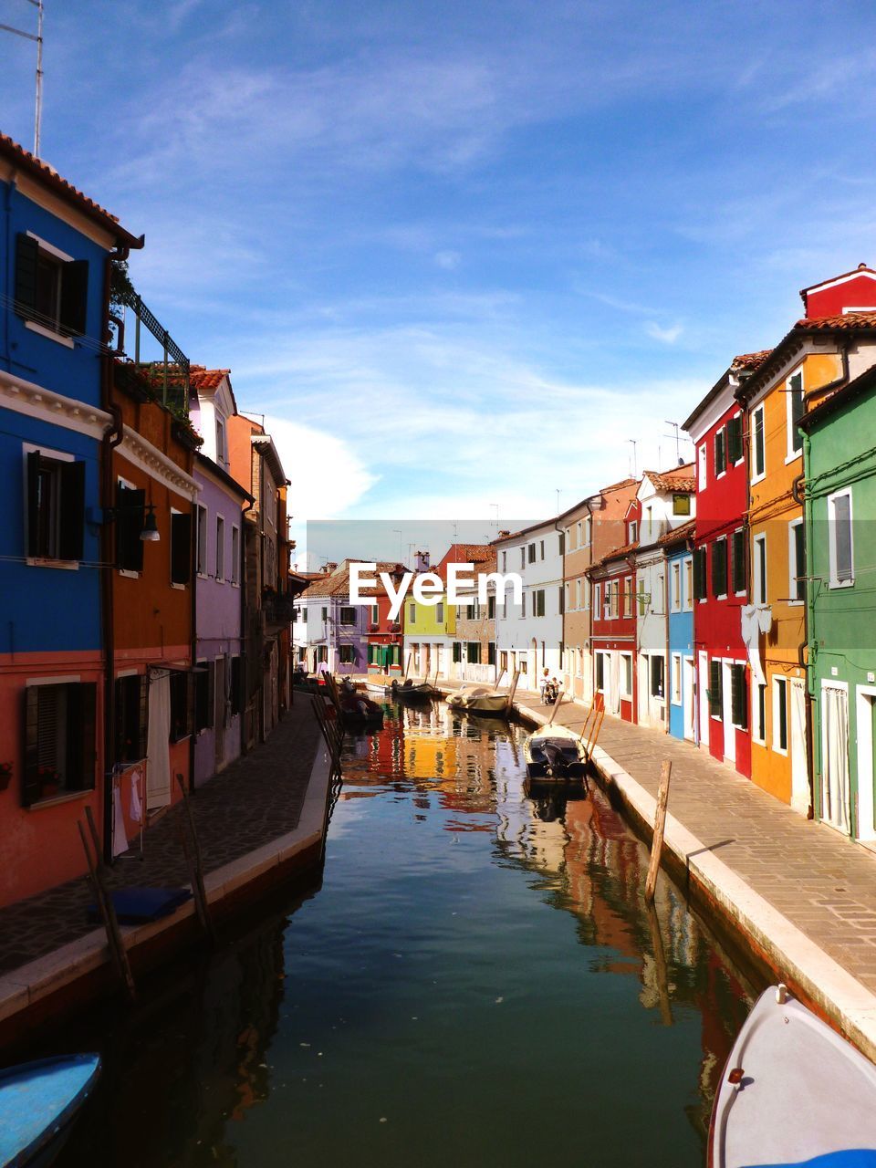 Boats in canal along buildings