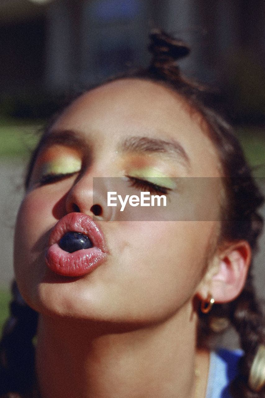 Close-up of girl sucking candy