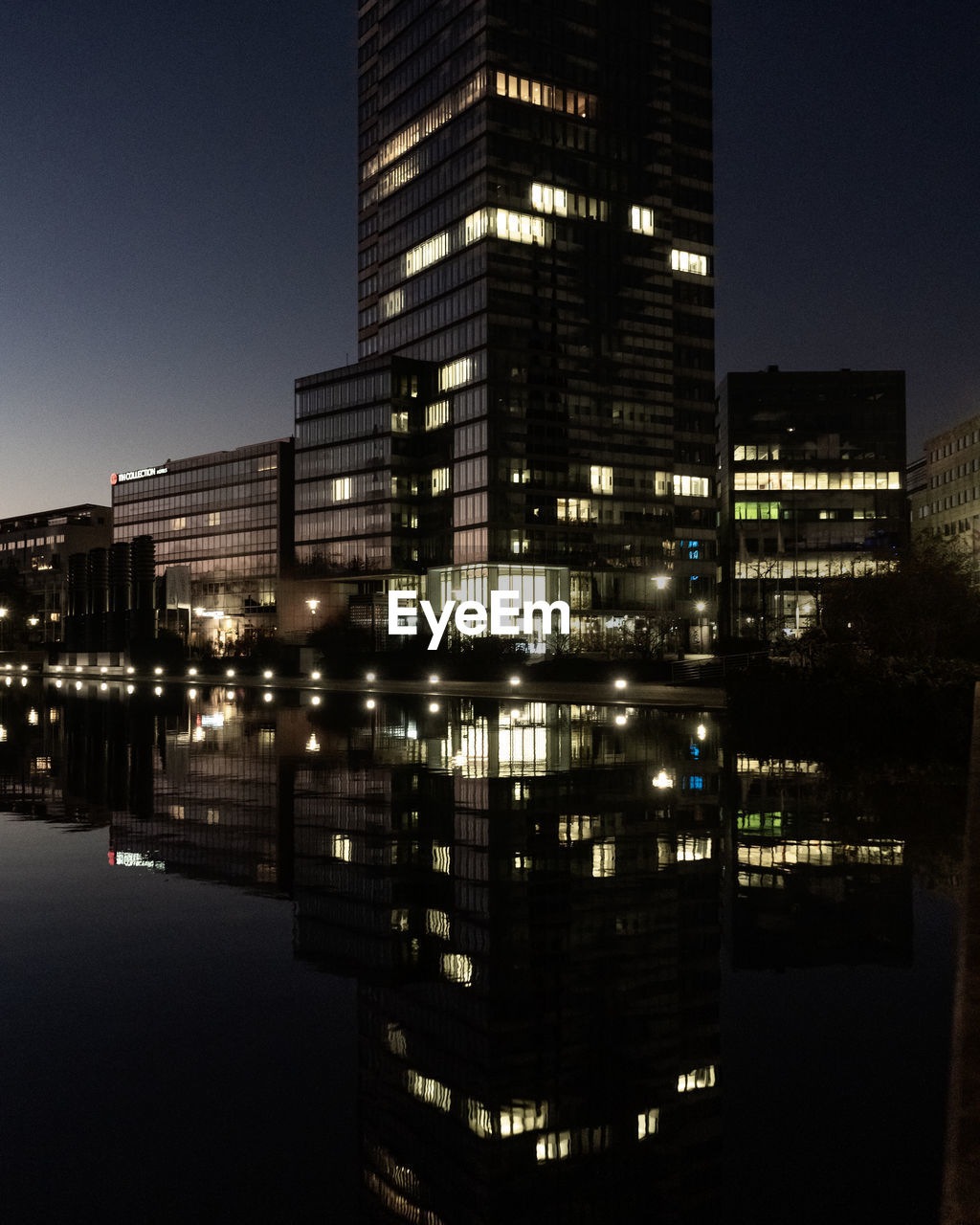 Reflection of illuminated buildings in city at night