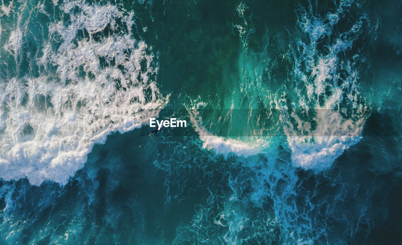 Aerial view of woman surfing in sea