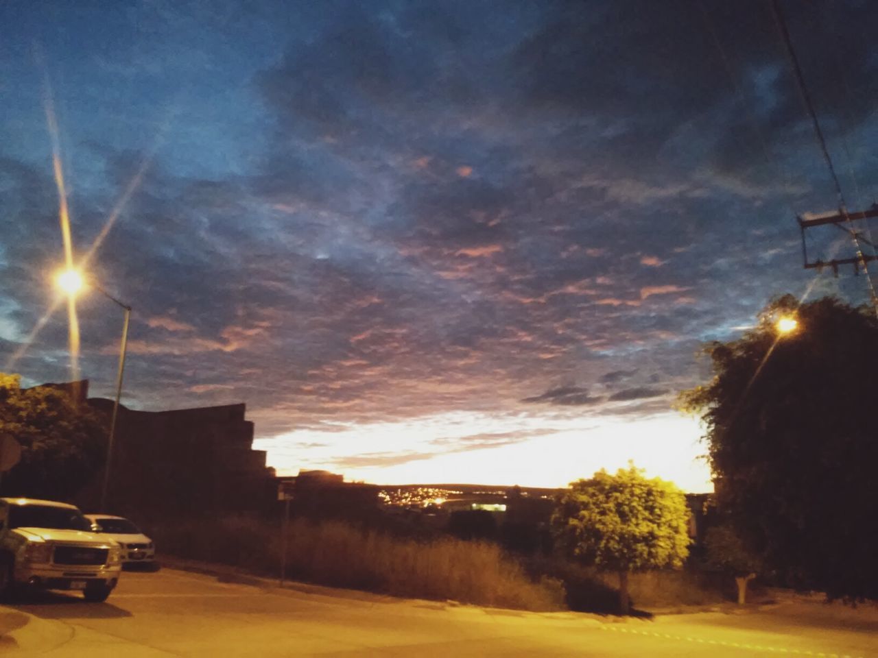 VIEW OF ROAD AGAINST CLOUDY SKY