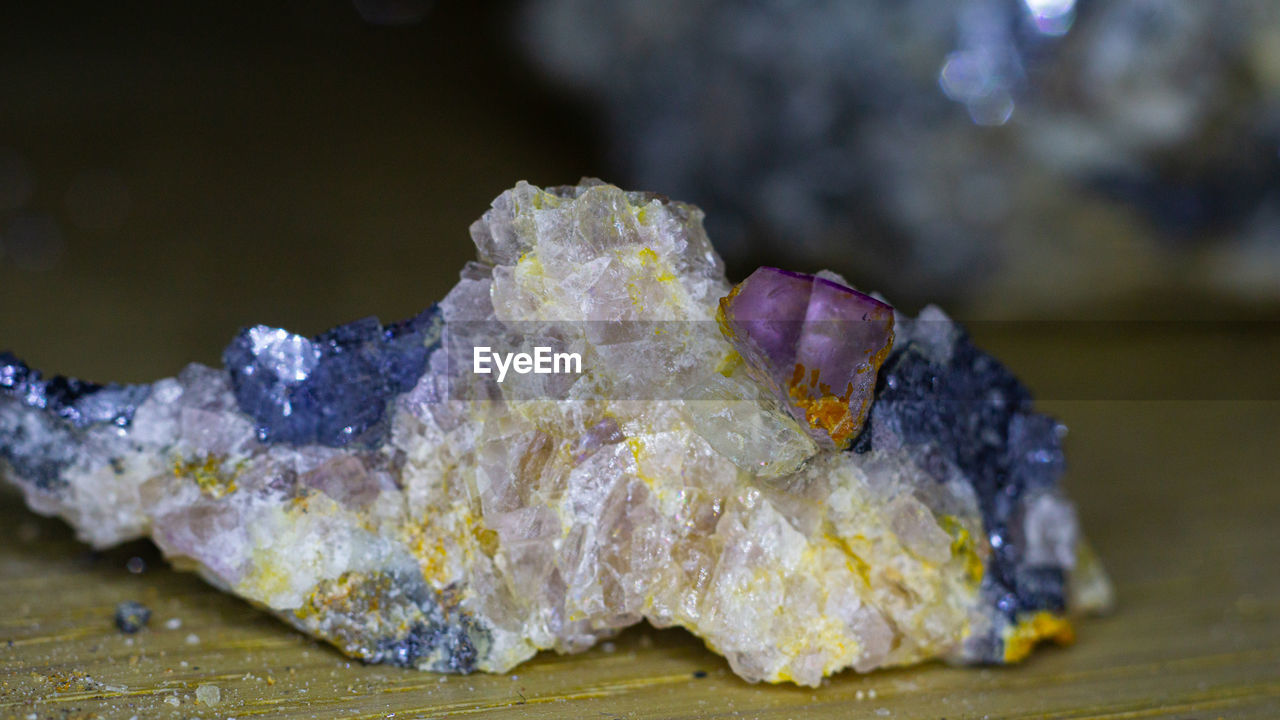 macro photography, yellow, mineral, close-up, no people, geology, nature, crystal, leaf, focus on foreground, outdoors