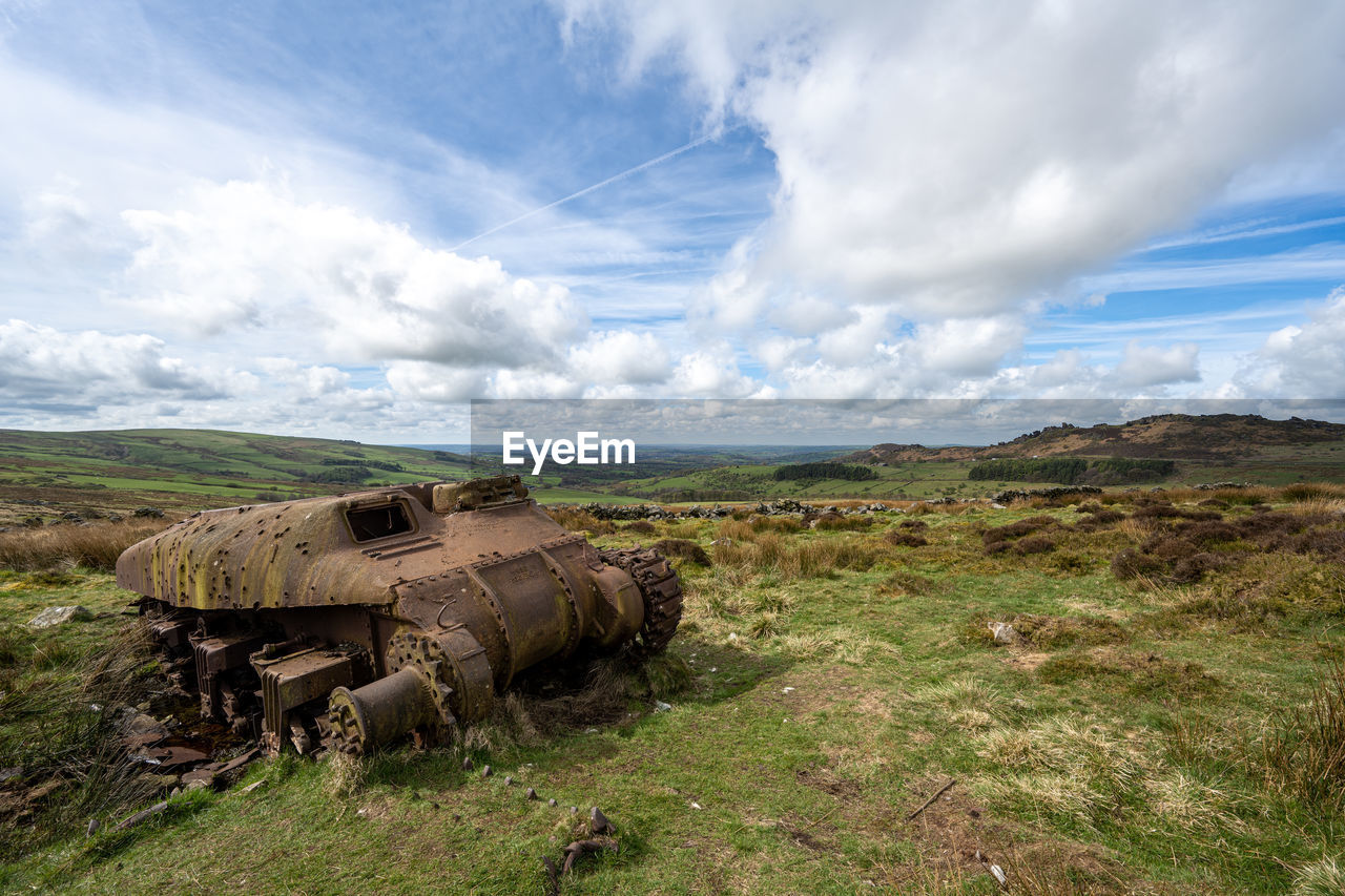 cloud, sky, landscape, environment, nature, land, scenics - nature, grass, rural area, wilderness, mountain, plant, no people, field, day, outdoors, non-urban scene, rural scene, natural environment, beauty in nature, terrain, history, vehicle, grassland, transportation, travel destinations, tank, travel