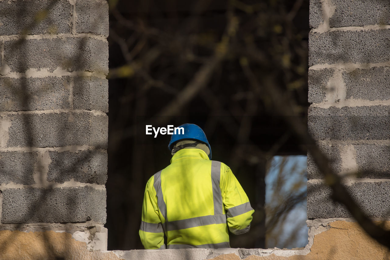 Rear view of man standing in building