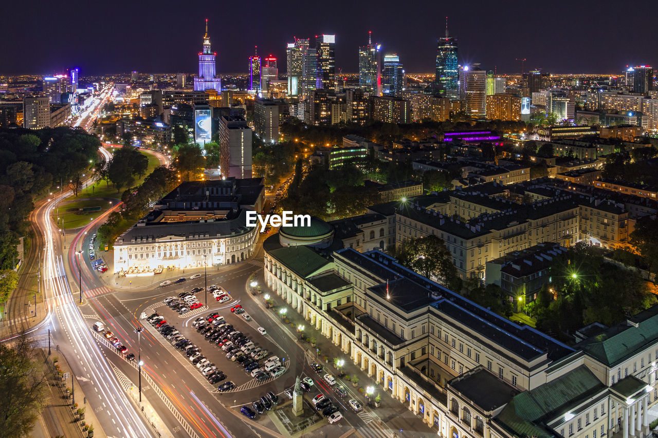 High angle view of city lit up at night