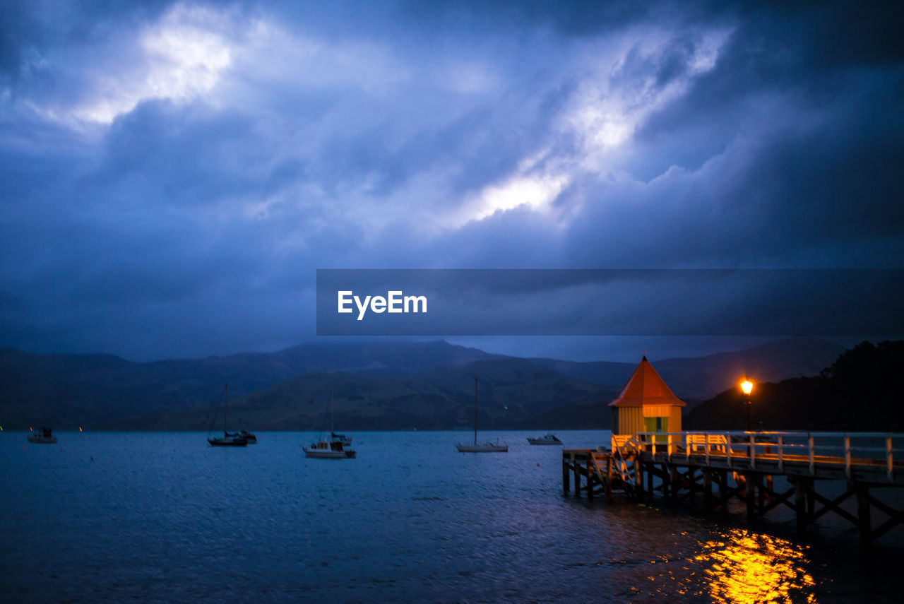 SCENIC VIEW OF SEA WITH MOUNTAINS IN BACKGROUND