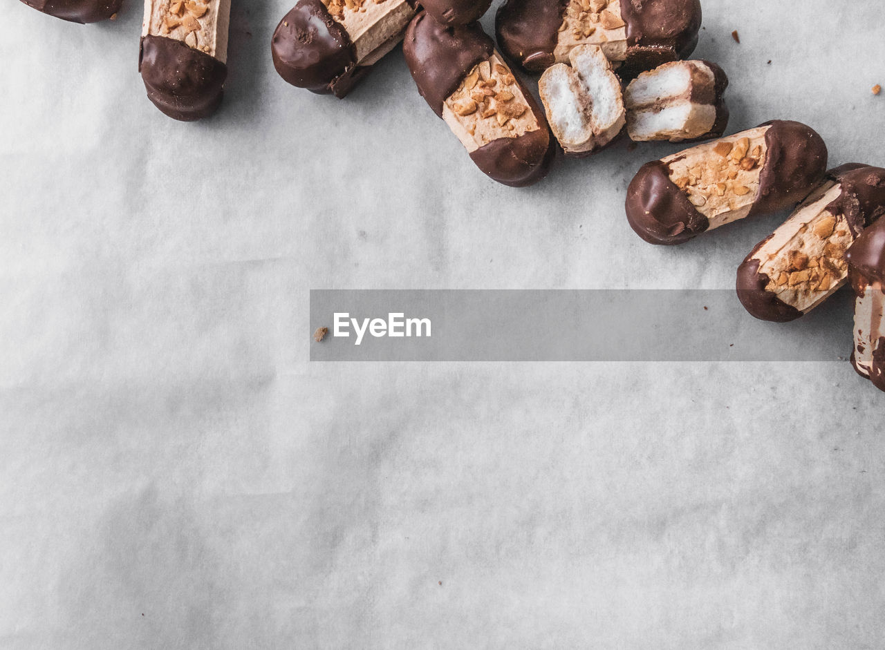 High angle view of bokkenpootjes dutch chocolate cookies against white background