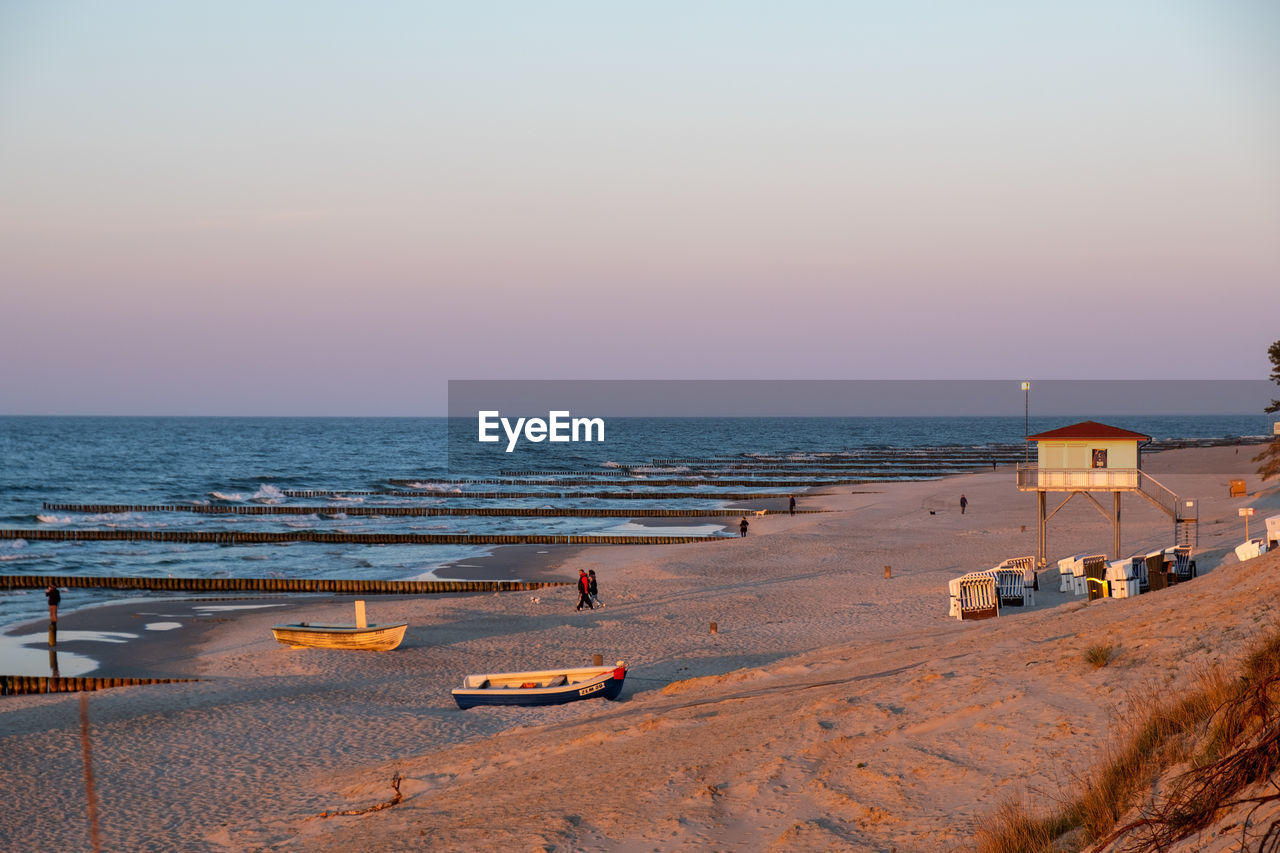 PANORAMIC VIEW OF BEACH AGAINST SKY DURING SUNSET