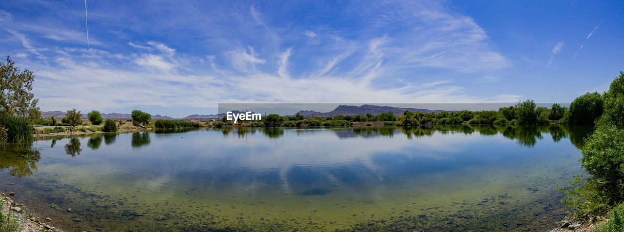 PANORAMIC VIEW OF LAKE AGAINST BLUE SKY