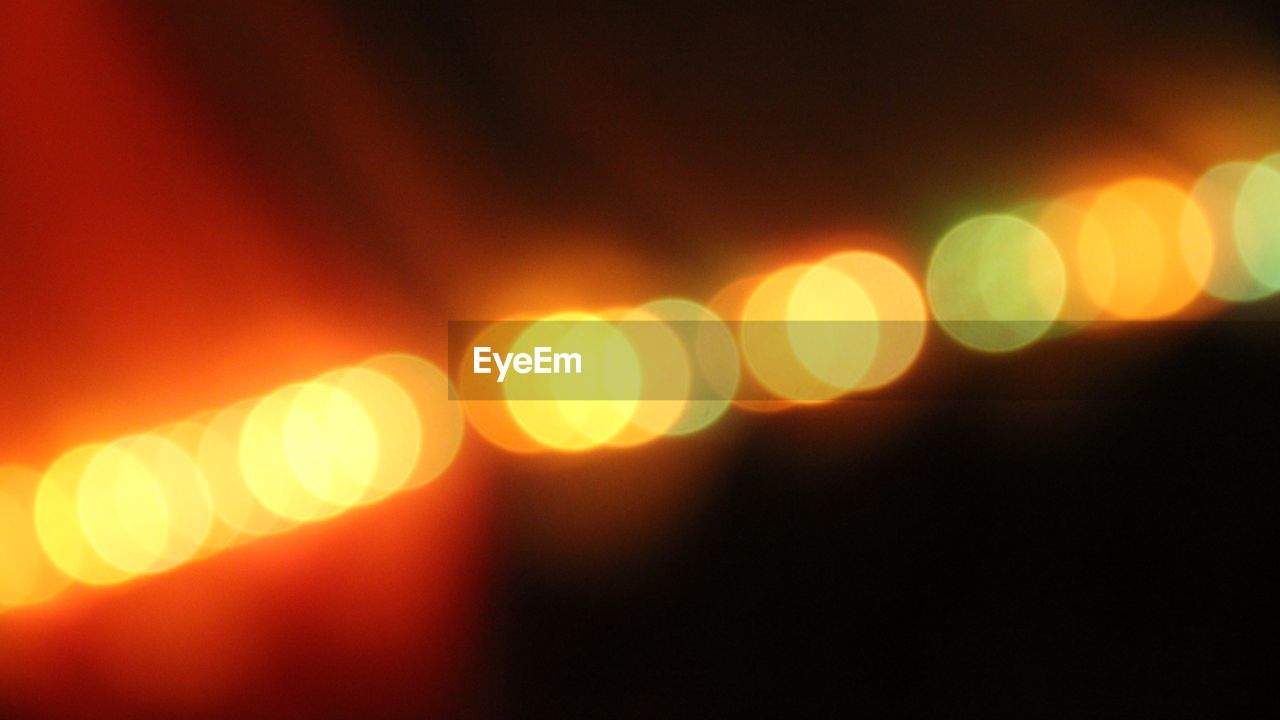 Close-up of illuminated spotlights at night