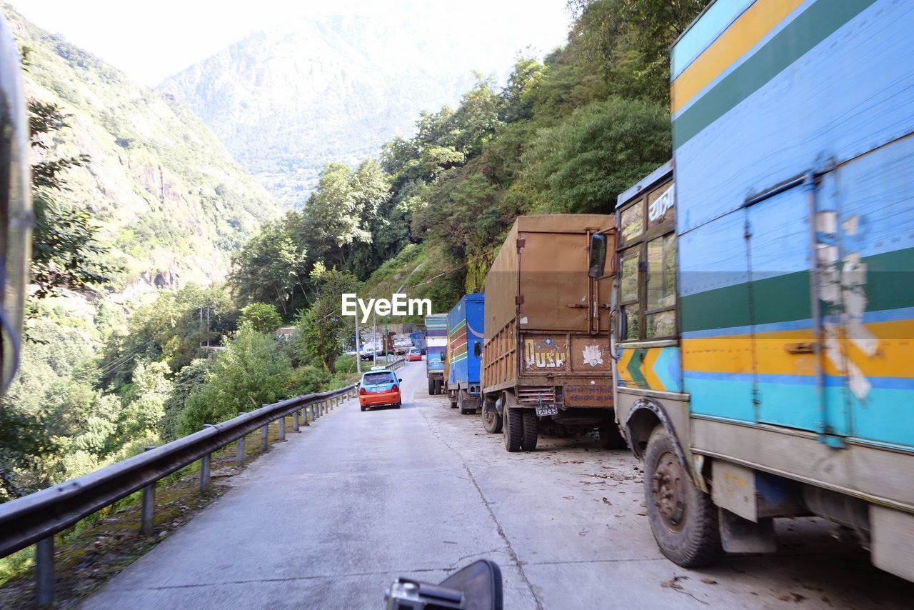 TRAIN ON ROAD AGAINST SKY