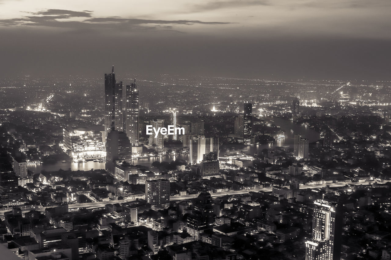 High angle view of illuminated city buildings against sky